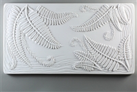 A long rectangular tile made of white ceramic. The carved texture shows several bunches of long ferns extending from the top left, top right, and bottom right corners. There are a few slightly waved lines around the tile border behind the ferns.