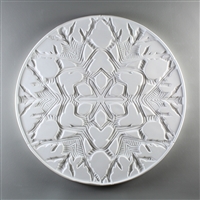 A circular tile made of white ceramic. The carved texture is occupied entirely by the design of a single snowflake with a thin border around the outside. The snowflake is intricate with many branches and lines in its pattern.