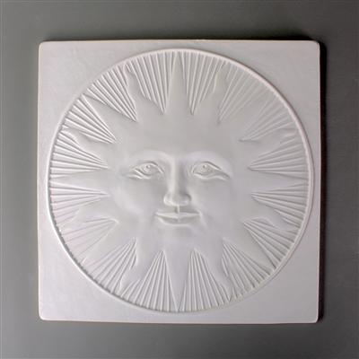 A large square tile made of white ceramic. The carved texture has a sun with a human face in the center. The sun has rays that are pointed and rays that are curved and is surrounded by additional lines radiating outward to the circle enclosing it all.