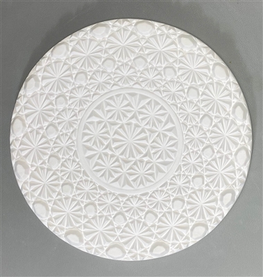 A circular tile made of white ceramic. The carved texture has a small center circle of a repeating diamond and circle patterns that mimic old crystal. The remainder of the mold repeats this pattern with a few more circles added.
