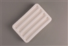 A rectangular white ceramic mold for fusing glass on a grey background. There are four identical evenly spaced rectangular cavities carved into it.