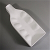 A bottle-shaped white ceramic mold for fusing glass on a grey background. The outer edges curve upwards, giving the mold a bowl-like shape. The mold has been carved with small, raised domes on either side to create a ruffled base.