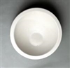 A tall circular white ceramic mold for fusing glass on a grey background. There is a flat border around the edge. It then slopes gently into a flat off-center circle base.