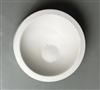 A tall circular white ceramic mold for fusing glass on a grey background. There is a flat border around the edge. It then slopes gently into a flat off-center circle base.