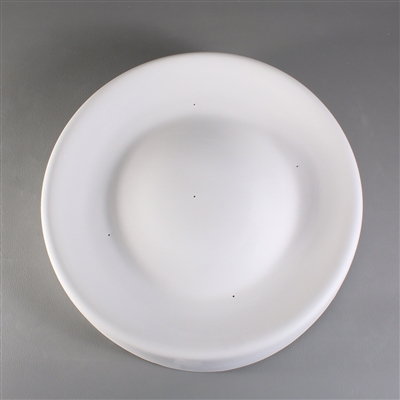 A circular white ceramic mold for fusing glass on a grey background. The edges are raised slightly and rounded. They then slope inwards before sloping back upwards to a large circular dome in the center. The domeâ€™s top is level with the mold edges.