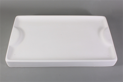 A rectangular white ceramic mold for fusing glass on a grey background. The edges are slightly raised, and there is a raised half circle at either end.