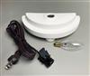 The supplies included in a Lamp Base Kit. The Lamp Base is a half-circle piece of white ceramic with small feet on the bottom, a raised lip along the outer edge, and a hole in the middle. An oval lightbulb is next to it, and a coiled cord to the left.