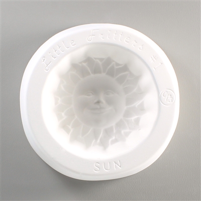 A round, white ceramic mold for fusing hot glass on a grey background. A stylized sun with a face has been carved into it. The mold has Little Fritters Sun engraved around the sun in script.