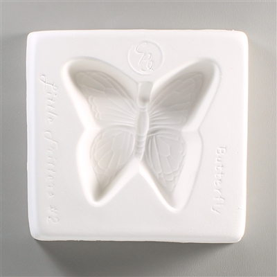 A square, white ceramic mold for fusing hot glass on a grey background. A butterfly with detailed wings has been carved into it. The mold has Little Fritters Butterfly written around the butterfly in script.
