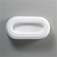 An oval, white ceramic mold for fusing hot glass on a grey background. A long oval with flat sides has been carved into it. The mold has LF10 Barrette engraved on the sides in print.