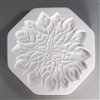 An octagonal, white ceramic mold for fusing hot glass on a grey background. A large and intricately detailed flat poinsettia flower has been carved into it.