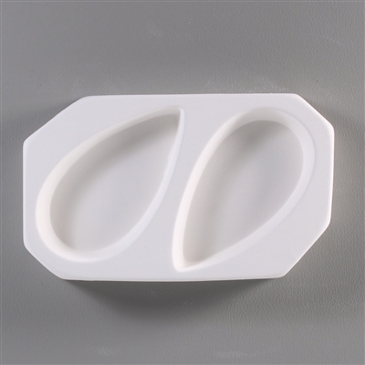 A roughly rectangular, white ceramic mold for fusing hot glass on a grey background. Two simple elongated tear shapes have been carved into it. The tears are facing opposite directions but are otherwise identical.