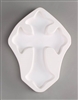 A cross-shaped white ceramic mold for fusing hot glass on a grey background. A simple cross has been carved into it.