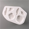 A roughly oval-shaped white ceramic mold for fusing hot glass on a grey background. Two flat rose flowers, one closed rose bud, and three slender leaves have been carved into it. The rose flowers are the same size, but each leaf is differently sized.