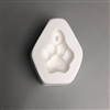 A roughly pentagonal white ceramic mold for fusing hot glass on a grey background. The impression of a paw print has been carved into it. There is a circle with a post at the top of the paw print allowing for stringing after firing.