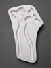 A roughly rectangular white ceramic mold for fusing hot glass on a grey background. Two stylized bees attached to wavy garden stakes have been carved into it. The left is a bee in profile with legs showing, while the right is a top-down view.