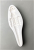 A long white ceramic mold for fusing hot glass on a grey background. A detailed nutcracker with legs tapering into an icicle has been carved into it. There is a post at the top of the nutcrackerâ€™s hat for hanging after firing.