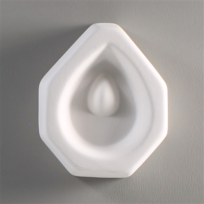 An octagonal white ceramic mold for fusing hot glass on a grey background. A teardrop shape has been carved into it. The teardrop has a teardrop-shaped post towards its top allowing for the glass to be strung as jewelry after fusing.