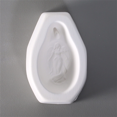 An octagonal white ceramic mold for fusing hot glass on a grey background. An oval-shaped cameo style design of an angel with outstretched arms has been carved into it. There is a post above the angel allowing for the final piece to be strung.