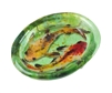A small oval bowl made from green fused glass. Two glass koi fish have been fused into it, swimming opposite directions. The koi have black fins and white bodies that have been speckled with yellow, orange, and red.