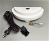The supplies included in a Lamp Base Kit. The Lamp Base is a half-circle piece of white ceramic with small feet on the bottom, a raised lip along the outer edge, and hole in the middle. An oval lightbulb is next to it, and a coiled cord to the left.