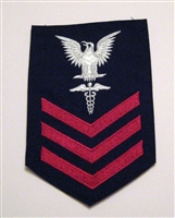 USCG Petty Officer First Class Rating Badge with Specialty:  HEALTH SERVICES TECHNICIAN (HST) - E6 - Red on Blue Serge