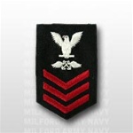 US Navy Petty Officer First Class Rating Badge - E6: AB - Aviation Boatswains Mate - Female - Red on Blue Serge