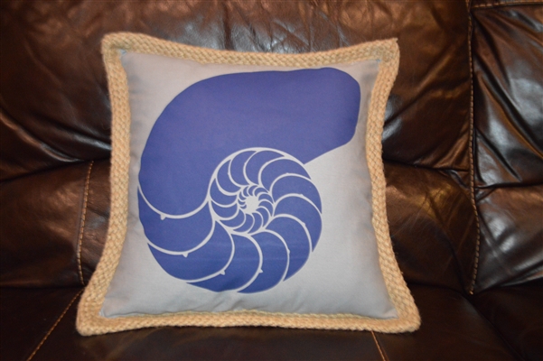 Blue nautilus shell on grey pillow