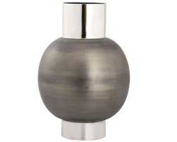 The Allred Vase is made from metal in a two-tone finish. This oversized vase has a banded base and cylindrical neck in a polished silver finish, and a rounded body in brushed gunmetal.