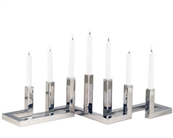 Stylish candle holder set in stainless steel and polished steel finish. A great accent for your home.