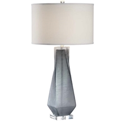 Anatoli Modern Lamp. Unpolished, charcoal gray glass, featuring a subtle twist shape, accented with brushed nickel highlights and crystal details. The round hardback drum shade is a light beige linen fabric with natural slubbing and matching double trim.