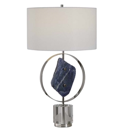 Xena Modern Table Lamp. This table lamp features a large lapis stone, which has been mined from Central Asia via the Indus Valley for thousands of years and has become highly valued for its rich blue color. The base of this piece showcases a thick crystal