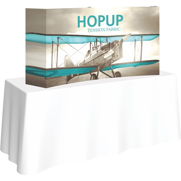 5ft Curved HopUp 2x1 Tabletop Fabric Trade Show Display with Full Fitted Graphic has a light weight, heavy duty frame that holds a fabric graphic mural. It sets up in seconds and can be packed away just as quickly after trade show or event