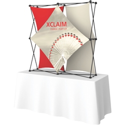 5ft Xclaim 3-D PopUp Table Top Display Kit 02 with Full Fabric Graphics. Portable tabletop displays and exhibits. Several different styles are available, including pop up frames with stretch fabric or fold up panels with custom graphics.
