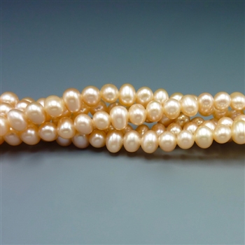 5mm round peachy pink fresh water pearls, one 16" strand