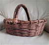 Handcrafted wickercwoven basket with wooden handle