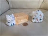 Two ceramic cats shakers table setting