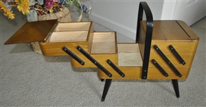 Wooden sewing or supply storage on footed base