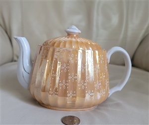 Teapot in orange gold luster, stripped design