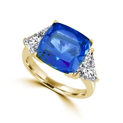Sapphira - Fantastic Ring with a plush 4 Ct. Cushion Cut Sapphire Essence Masterpiece that highlights by each side of Trilliant accents.6 Cts. t.w. in 14K Solid White Gold, to chase your blues away!