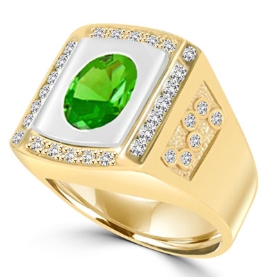 An impressive Men's Ring in two-toned 14K Solid Yellow Gold features a 4.0 cts. Oval Emerald stone set flush in a platform of white gold surrounded by melee, with double jolts of melee on each shank. 4.50 cts. t.w.