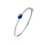 Bangle Bracelet - 2.0 Cts.Oval cut Sapphire Essence set in center with sparkling Diamond Essence Melee going around the Bangle, 4.0 Cts.T.W. set in Platinum Plated Sterling Silver.