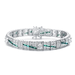 A stunner, this Platinum Plated Sterling Silver 7.25" bracelet features five round brilliant stones, 0.5 cts each, joined by melee and emerald baguettes . 14.0 cts. T.W.