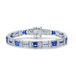 A stunner, this Platinum Plated Sterling Silver 7.25" bracelet features nine princess sapphire stones, 0.25 cts each, joined by melee. 17.0 cts. T.W.