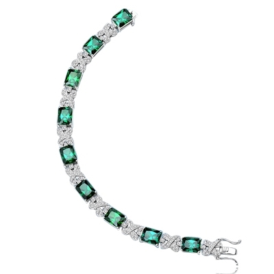 A stunner, this Platinum Plated Sterling Silver 7" bracelet features nine radiant-cut Emerald stones, 3.0 cts each, joined by stylish ribbons of melee. 29.0 cts. T.W.