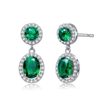 Emerald Essence 0.5 Ct. Round stones and 2.0 Cts. Oval cut stones, set in four prongs settings and surrounded by Diamond Essence Melee. Looks very attractive. 6.50 Cts.T.W. set in Platinum Plated Sterling Silver.