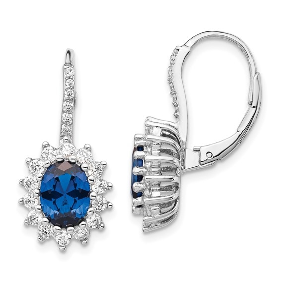 An alluring pair of prong set earrings for women with simulated oval cut sapphire in center surrounded by round brilliant melee Diamonds in floral pattern by Diamond Essence set in platinum plated sterling silver. 5.0 Cts.t.w.