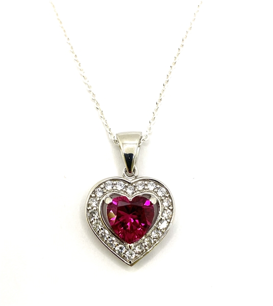 Heart shape Ruby Essence stone in prong setting, is surrounded by round brilliant Diamond Essence stones, making another heart. 2.5 cts.t.w. in Platinum Plated Sterling Silver.