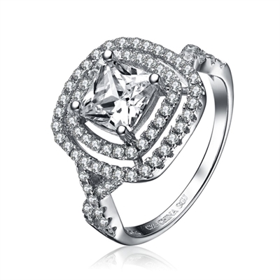 Diamond Essence Designer ring with 1.5 carat Princess cut center stone in prong setting, stands out with two outlines of diamond essence melee and intertwined design on band. 3.25 cts.t.w. in Platinum Plated sterling Silver.