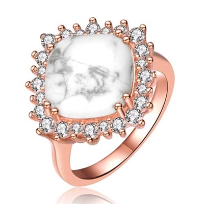 Diamond Essence Ring With How Lite Center Surrounded By Melee Set In 8 Prongs In Rose Plated Sterling Silver.